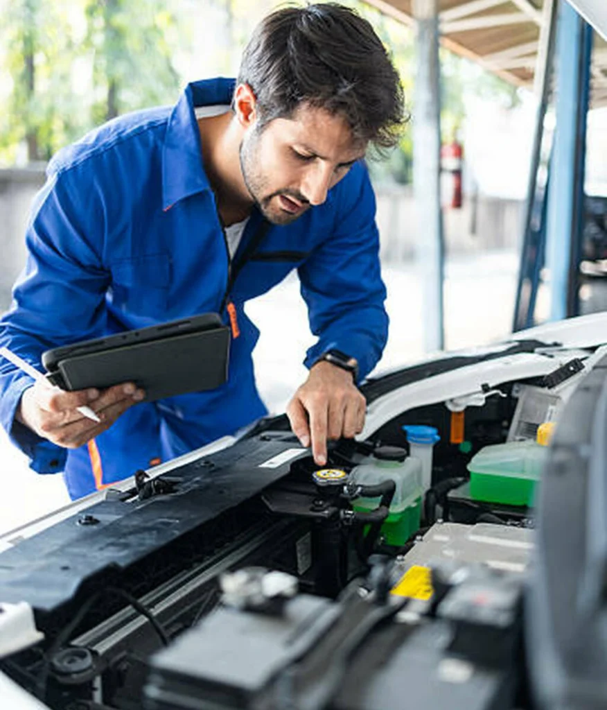 mechanic-technician-man-in-uniform-works-with-broken-electric-car-electric-cars-hood-2