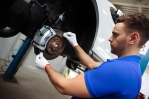 squeaky-brakes-technician-repairing-car-brakes-in-garage