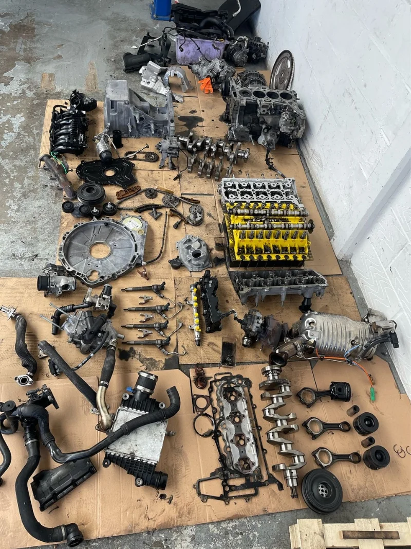 AutoNet-VIP-engine-parts-and-car-components-carefully-disassembled-and-organised-during-repair-work