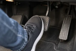 Driver-pressing-the-brake-pedal-while-checking-symptoms-linked-to-Warped-Brake-Rotors
